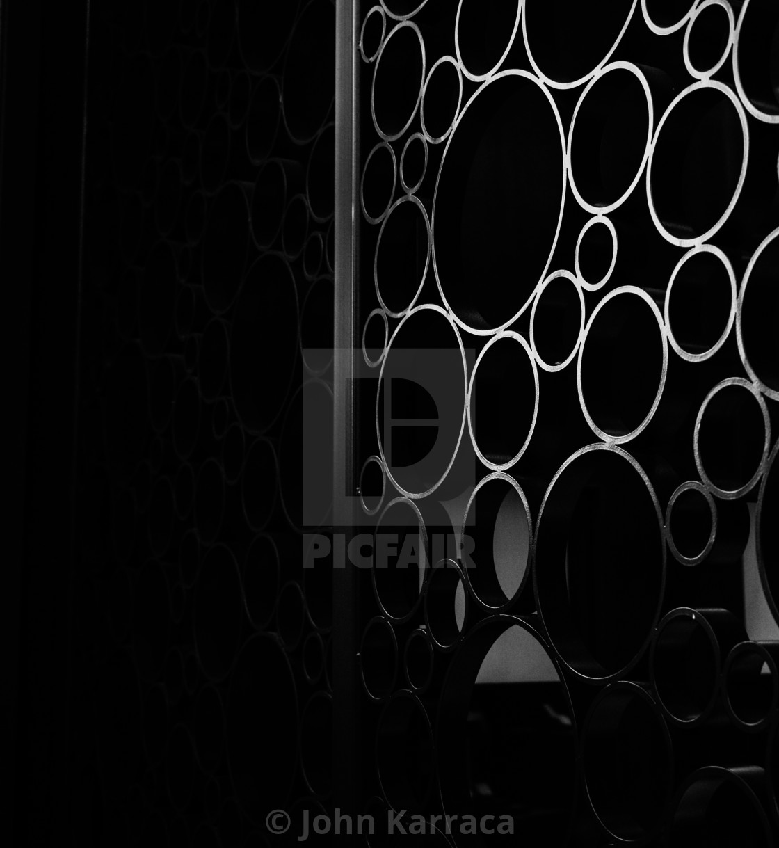 "black steel circles on a gate create in an elegant background" by John Karraca - $4.58 "black steel circles on a gate create in an elegant background" stock image
