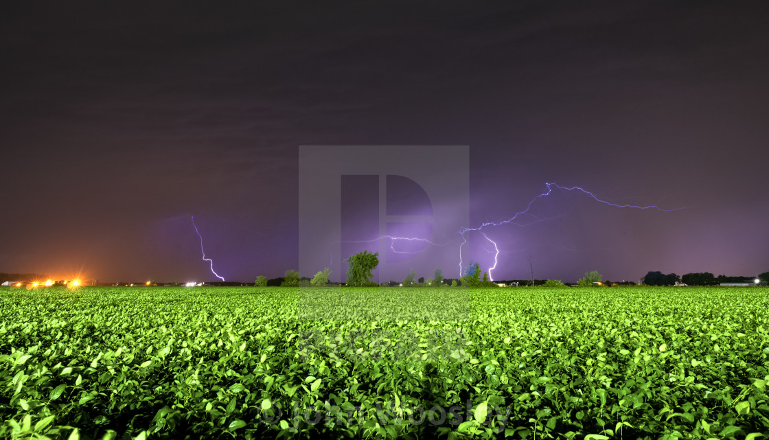 "Lightning over field" stock image