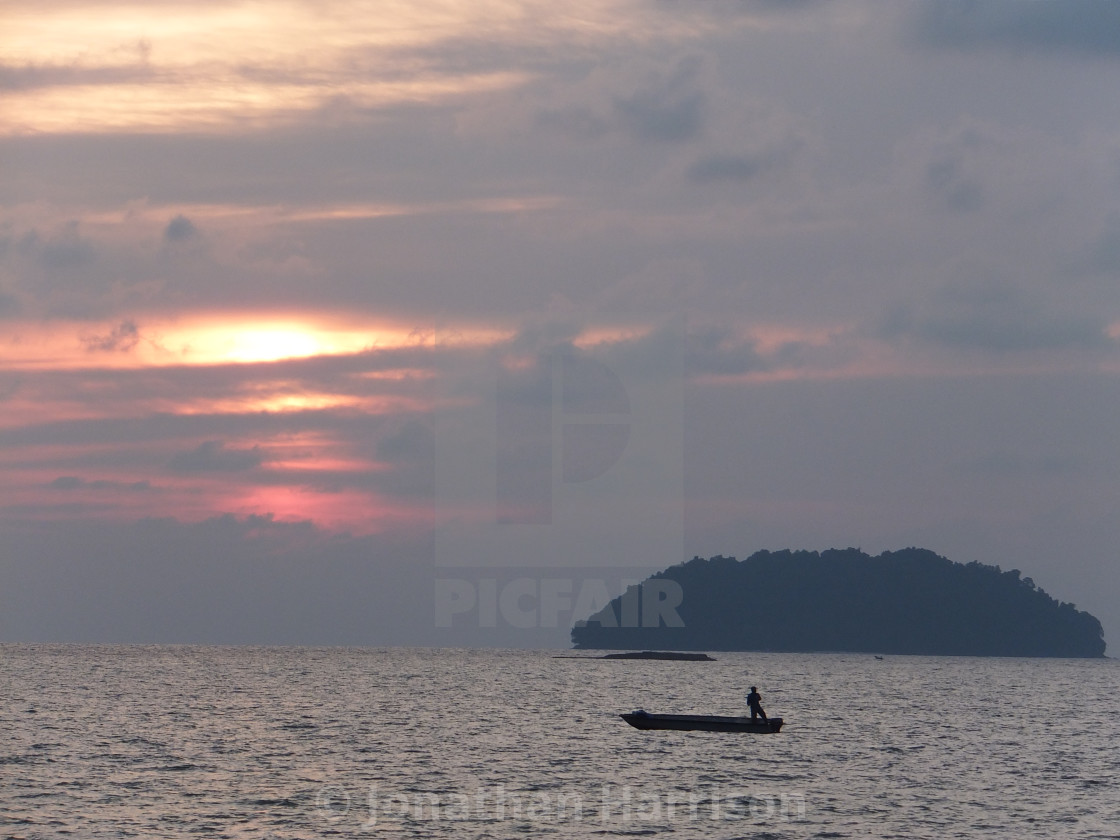 "Fisherman at Sunset, Shangri-La Tatung Aru" by Jonathan Harrison - $12.59 "Fisherman at Sunset, Shangri-La Tatung Aru" stock image