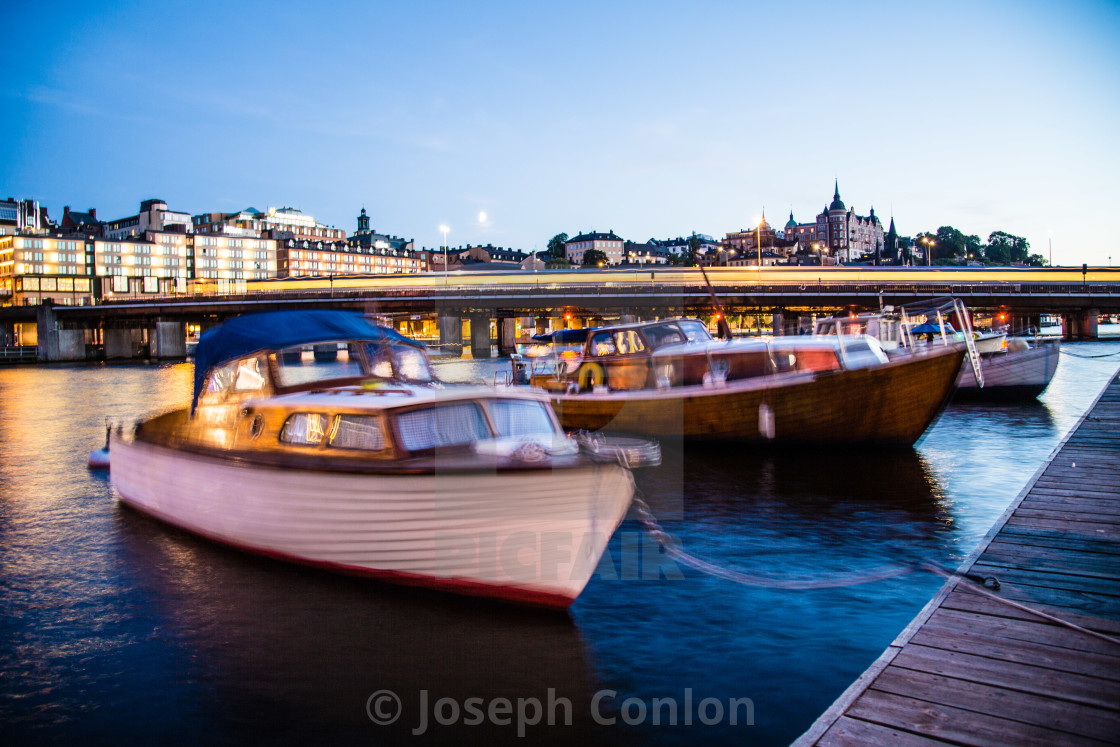 "Boats in Stockholm at night with train" by Joseph Conlon - $10.69 "Boats in Stockholm at night with train" stock image