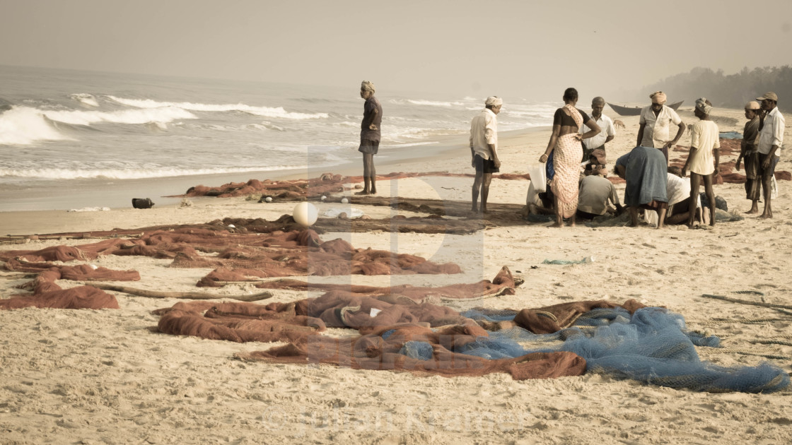 "Fisherfolk and their nets on the beach - India" stock image