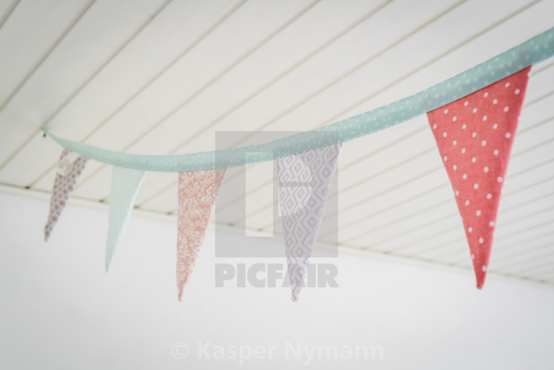 Colorful Birthday Flags In Pastel Colors Hanging From A Ceiling
