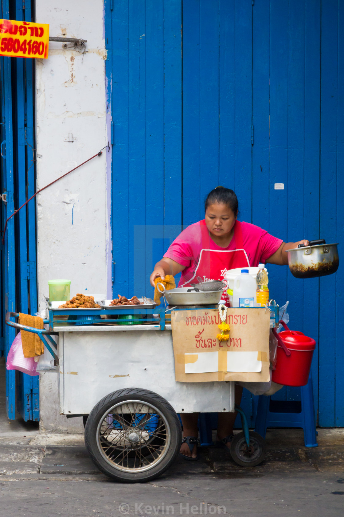 Woman Street Food Vendor Against A Blue And White Background