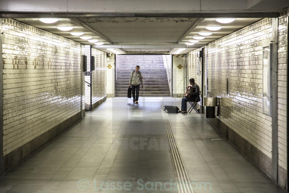 "A musician in empty tunnel" by Lasse Sandström - £12.40 "A musician in empty tunnel" stock image
