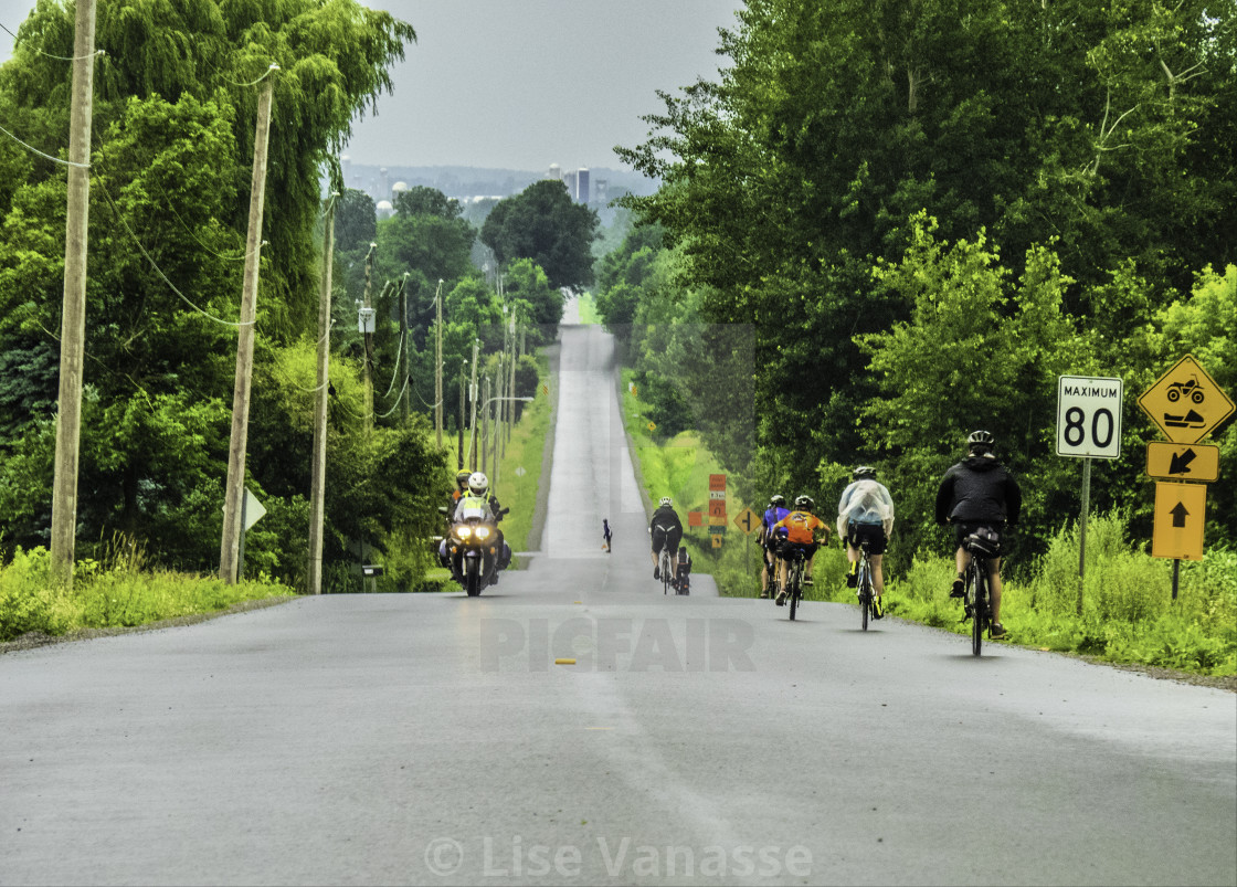 "A group of cyclists descending a hill." by Lise Vanasse - $1.52 "A group of cyclists descending a hill." stock image