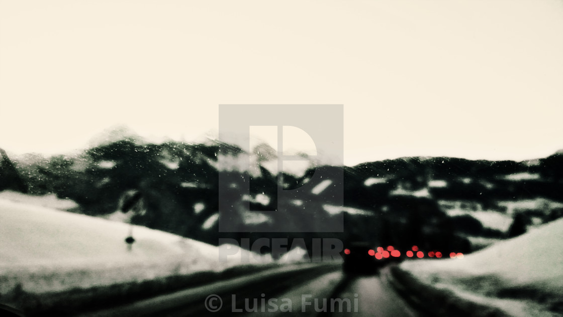 "Snowy blurred landscape on mountain road with stormy weather" stock image