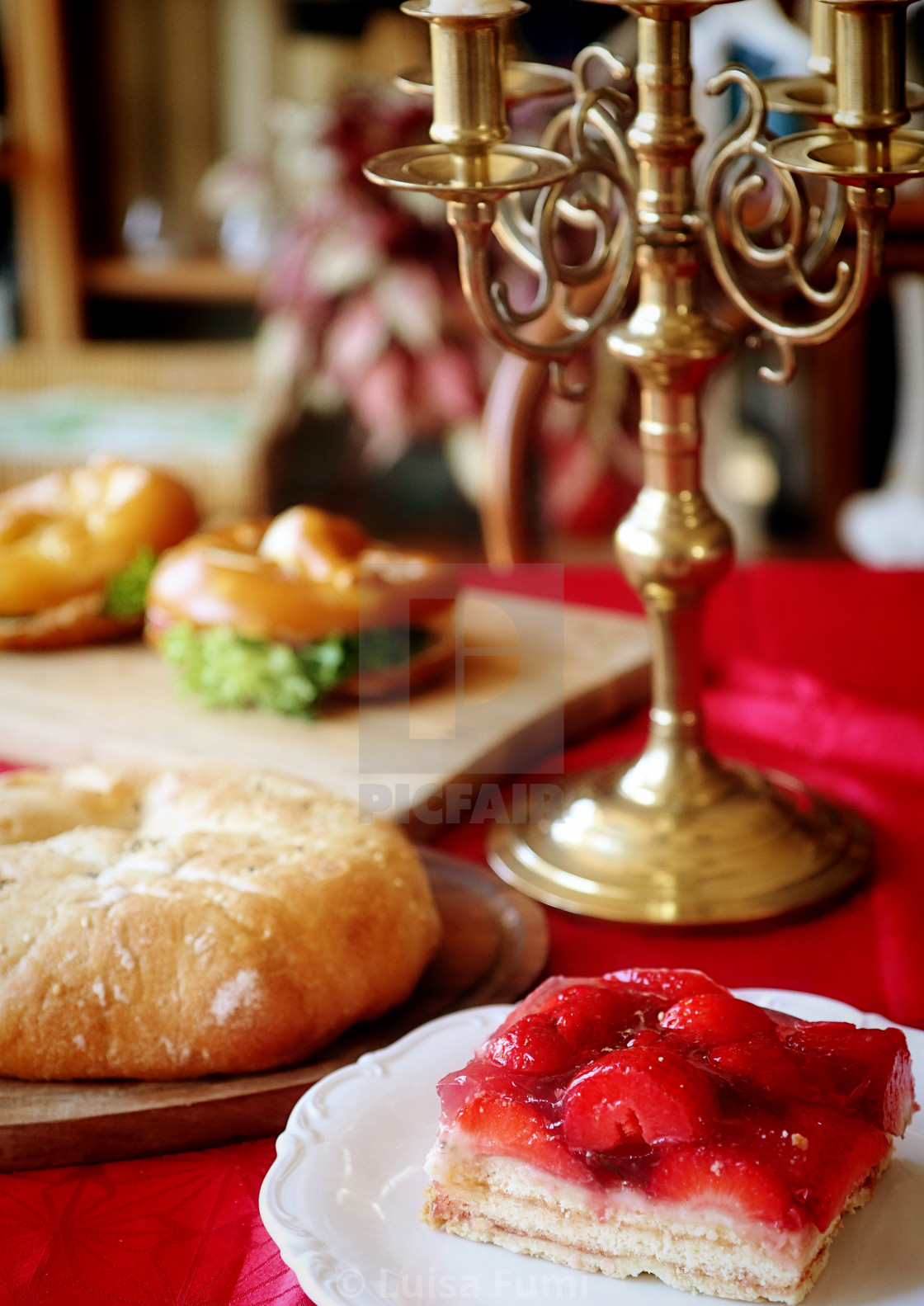 "Homemade bakery on the table at home: strawberry cake, flat pizza, stuffed sandwiches, soft focus" stock image