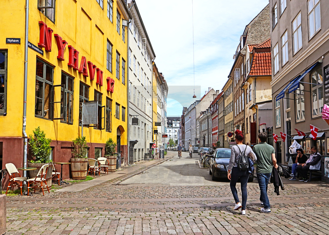 "COPENHAGEN, DENMARK - JUNE 16, 2019 Tourists at Nyhavn harbor district famous..." stock image