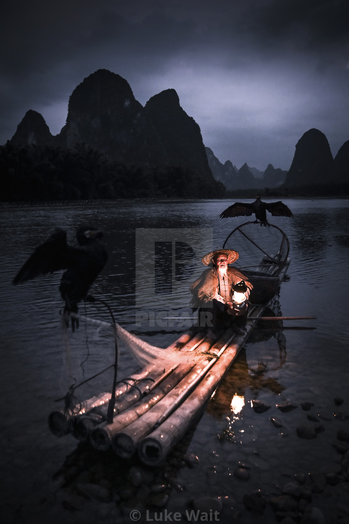 "Cormorant fisherman setting in for the night" stock image