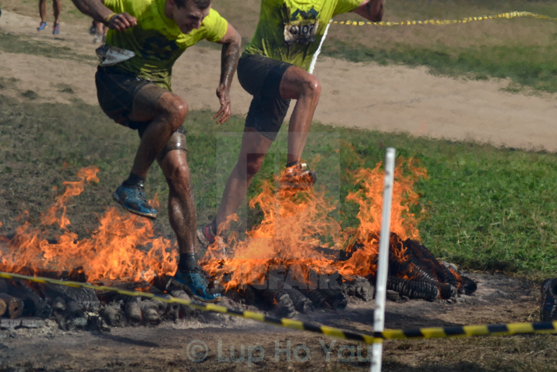 "Wild Warrior challenge fire leap" by Lup Ho Yau - $7.79 "Wild Warrior challenge fire leap" stock image