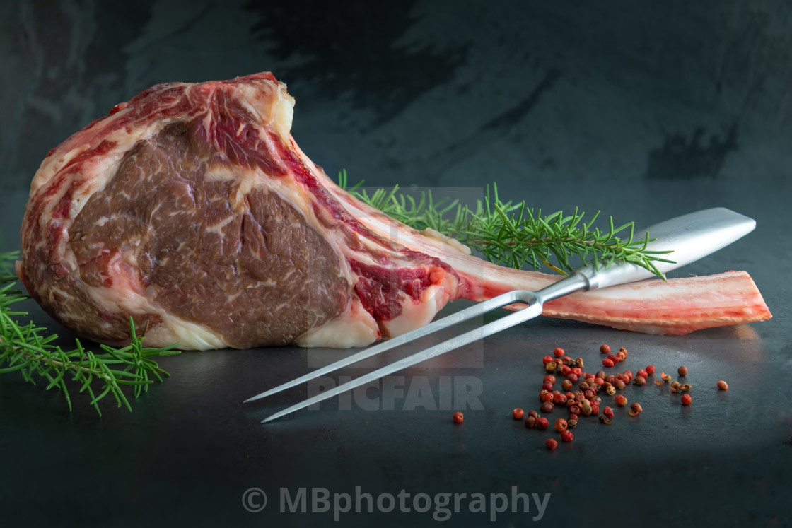 "Raw ,dry-aged wagyu tomahawk steak with rosemary, pepper and a m" stock image