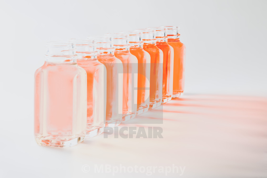 "Bottles with coral colored fluids in different shades" stock image