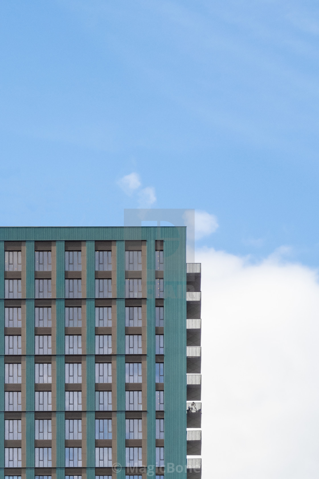 "Block of modern apartments with balconies against a blue sky bac" stock image