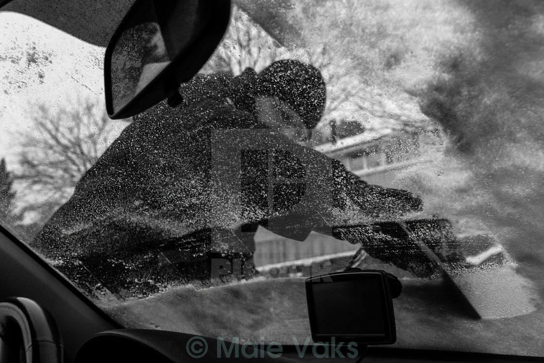 "Man Scraping Ice Off Car Window" stock image