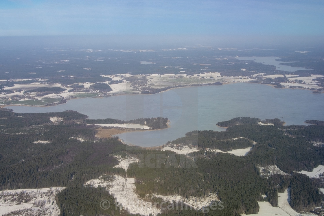 "Aerial landscape snowy winter view of forest and lake" by MallorcaImages - $12.33 "Aerial landscape snowy winter view of forest and lake" stock image