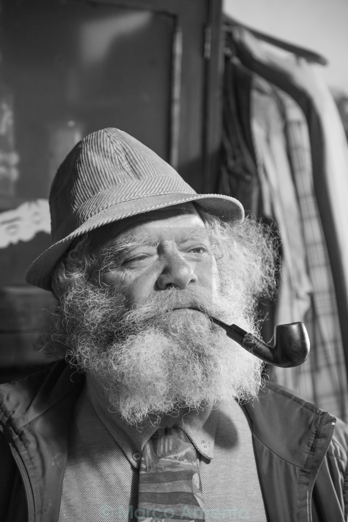 "portrait of a cute old man with a long beard smoking a pipe" stock image