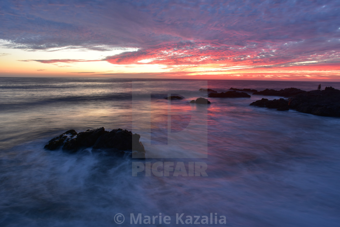 "pink sunset sky reflected in ocean water rocky coast Baja, Mexico" by Marie Kazalia - £12.40 "pink sunset sky reflected in ocean water rocky coast Baja, Mexico" stock image
