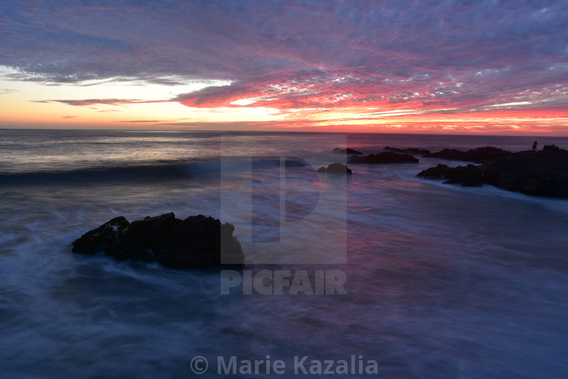 "pink sunset sky reflected in ocean water rocky coast Baja, Mexico" by Marie Kazalia - £12.40 "pink sunset sky reflected in ocean water rocky coast Baja, Mexico" stock image