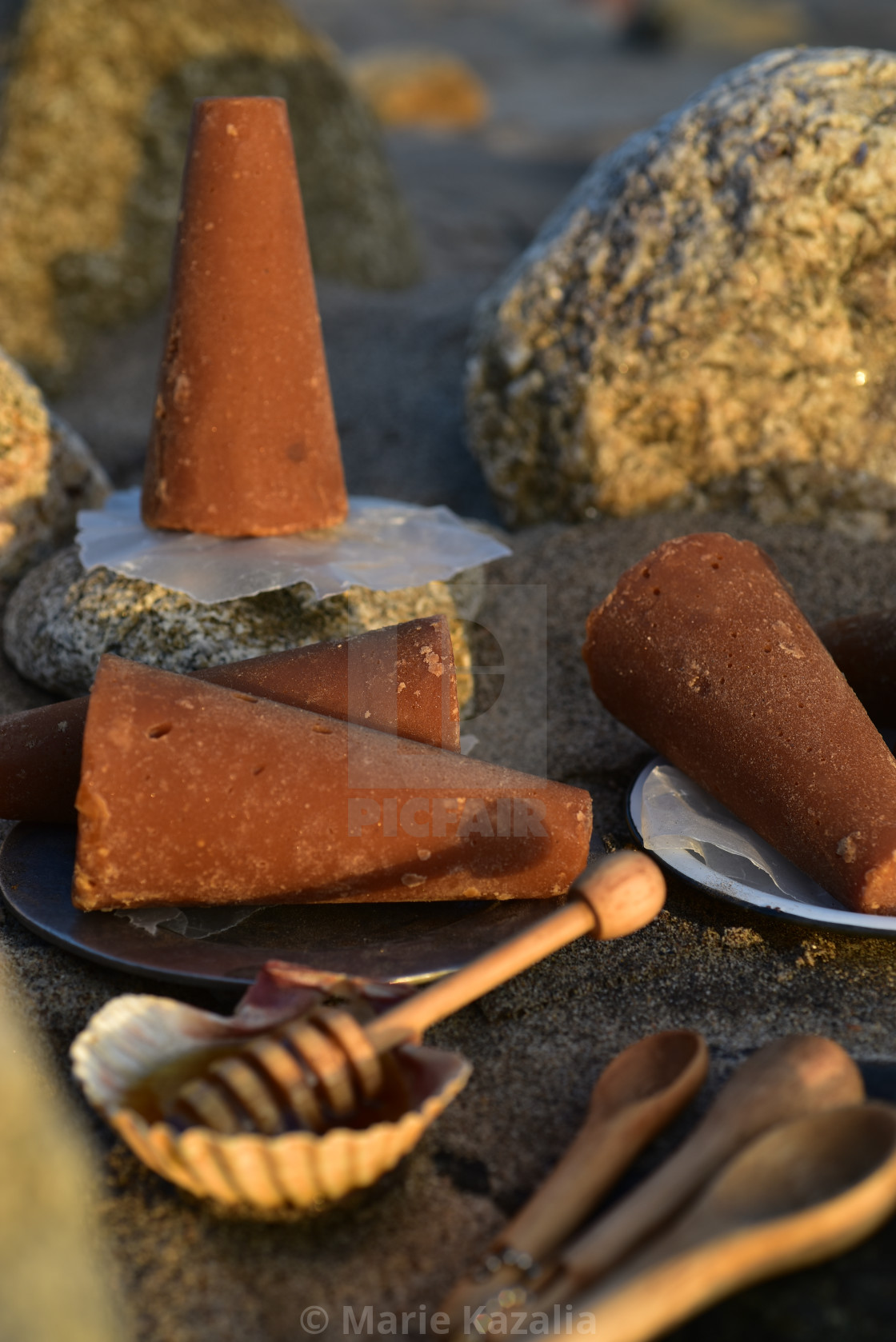 "piloncillo brown sugar and honey still life on rock and sand beach shore" by Marie Kazalia - $15.16 "piloncillo brown sugar and honey still life on rock and sand beach shore" stock image