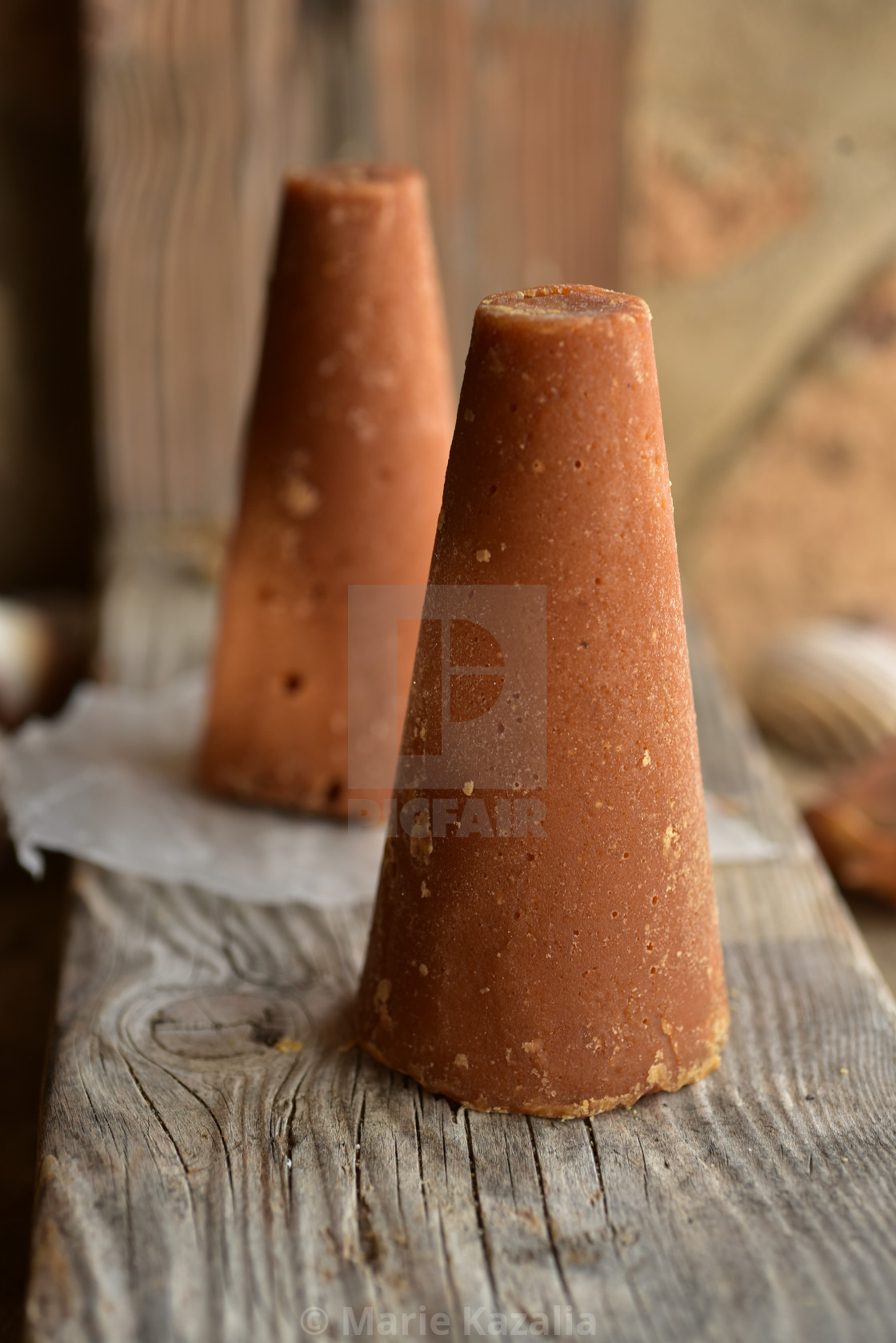 "piloncillo brown sugar and honey still life on rock and sand beach shore" by Marie Kazalia - $15.16 "piloncillo brown sugar and honey still life on rock and sand beach shore" stock image