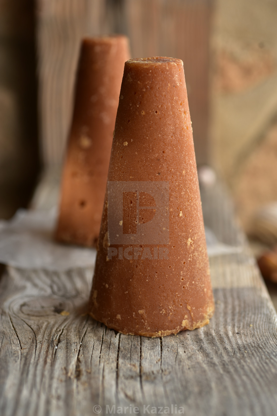 "piloncillo brown sugar and honey still life on rock and sand beach shore" by Marie Kazalia - $15.16 "piloncillo brown sugar and honey still life on rock and sand beach shore" stock image