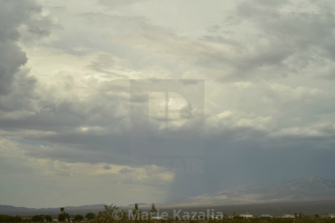 "rain clouds in vast sky over Mojave Desert landscape and houses in town of Pahrump, Nevada" by Marie Kazalia - $15.29 "rain clouds in vast sky over Mojave Desert landscape and houses in town of Pahrump, Nevada" stock image