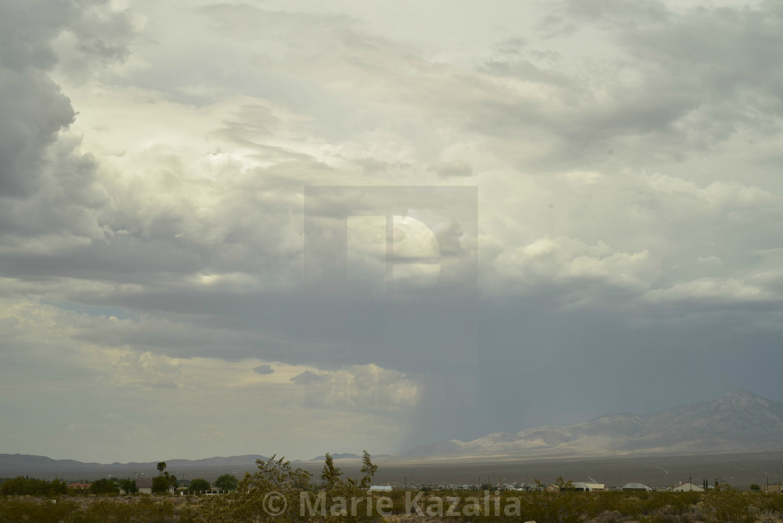 "rain clouds in vast sky over Mojave Desert landscape and houses in town of Pahrump, Nevada" by Marie Kazalia - $15.29 "rain clouds in vast sky over Mojave Desert landscape and houses in town of Pahrump, Nevada" stock image