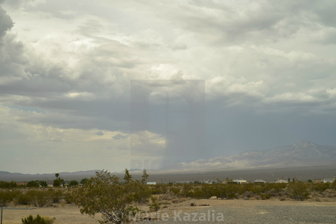 "rain clouds in vast sky over Mojave Desert landscape and houses in town of Pahrump, Nevada" by Marie Kazalia - $15.29 "rain clouds in vast sky over Mojave Desert landscape and houses in town of Pahrump, Nevada" stock image