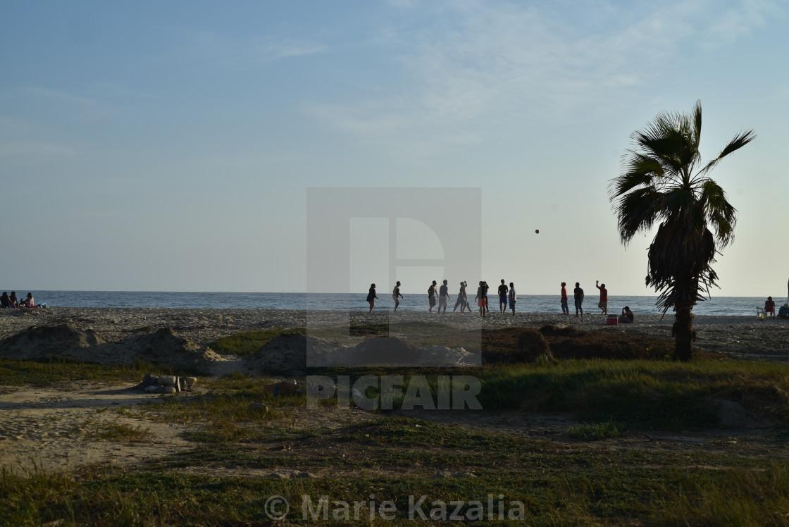 "group of young men in silhouette playing volleyball on Baja beach, Mexico" by Marie Kazalia - $15.16 "group of young men in silhouette playing volleyball on Baja beach, Mexico" stock image