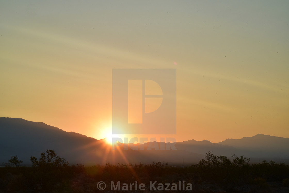 "sun rising over ridge Spring Mountains Mojave Desert town Pahrump, Nevada, USA" by Marie Kazalia - $15.44 "sun rising over ridge Spring Mountains Mojave Desert town Pahrump, Nevada, USA" stock image