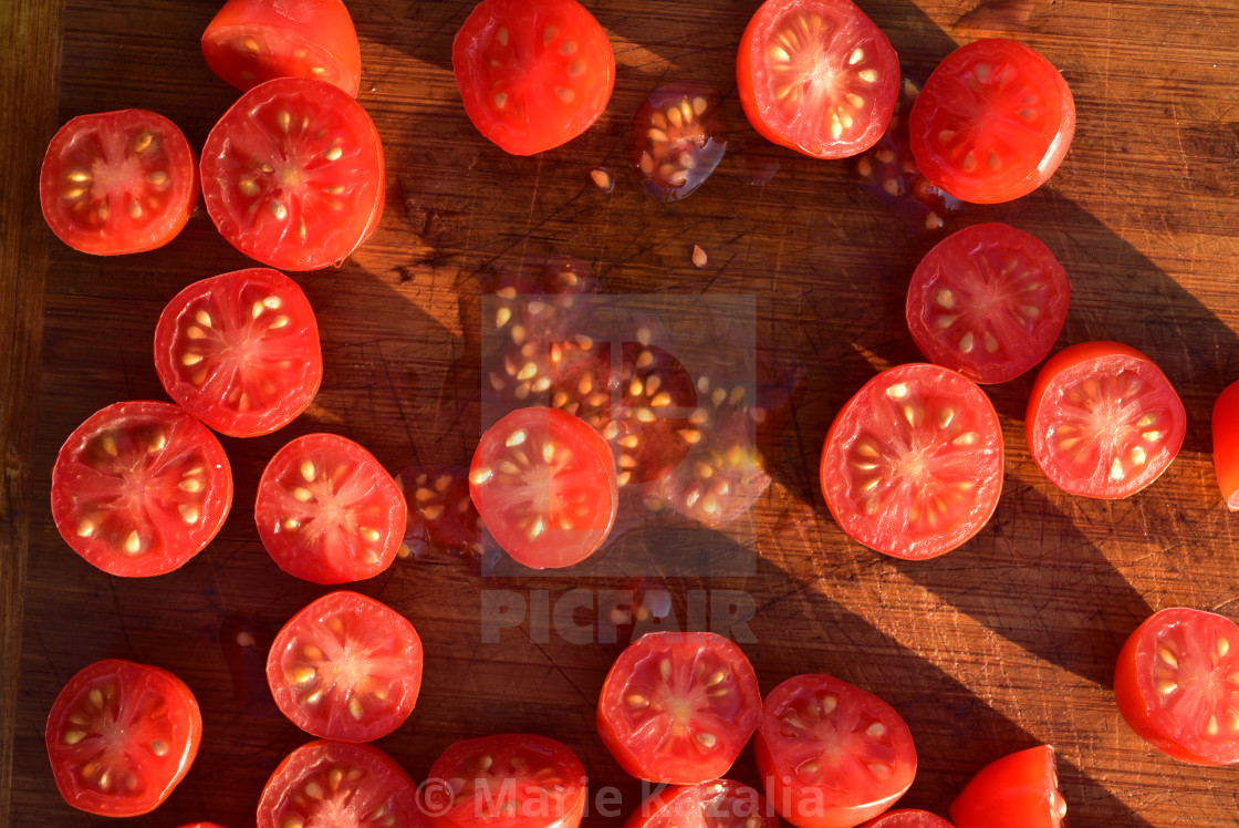 "above view of grape tomatoes cut into halves on wood cutting board" by Marie Kazalia - $15.44 "above view of grape tomatoes cut into halves on wood cutting board" stock image