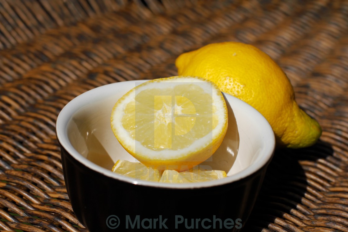 "Refreshing Sliced Lemon Outdoors on Wooden Wicker" stock image