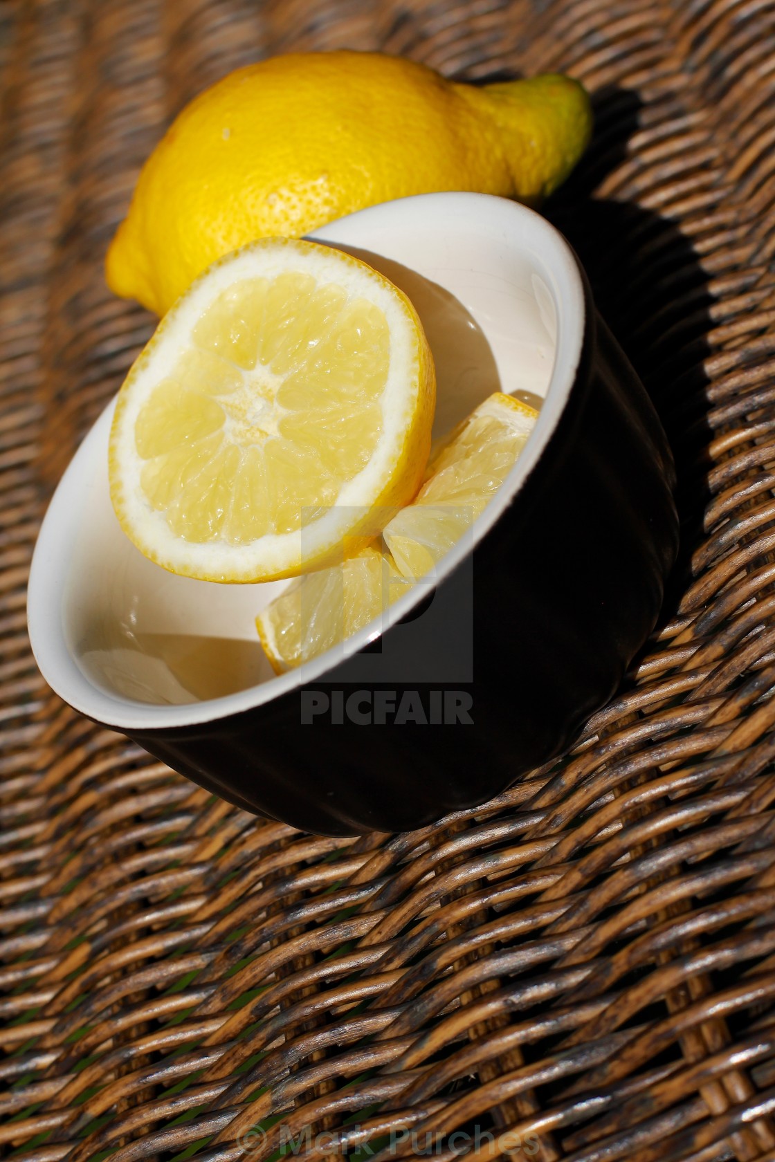 "Refreshing Sliced Lemon Outdoors on Wooden Wicker" stock image