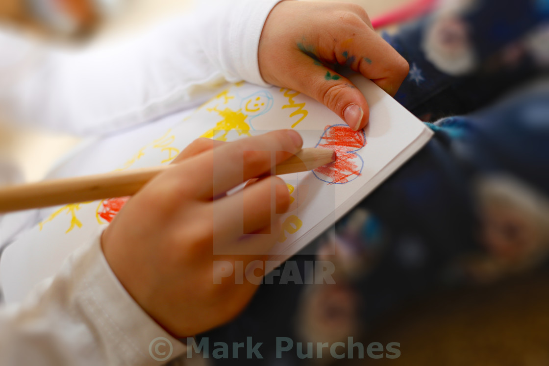 "Little Girl Drawing Heart for Mother's Day" stock image