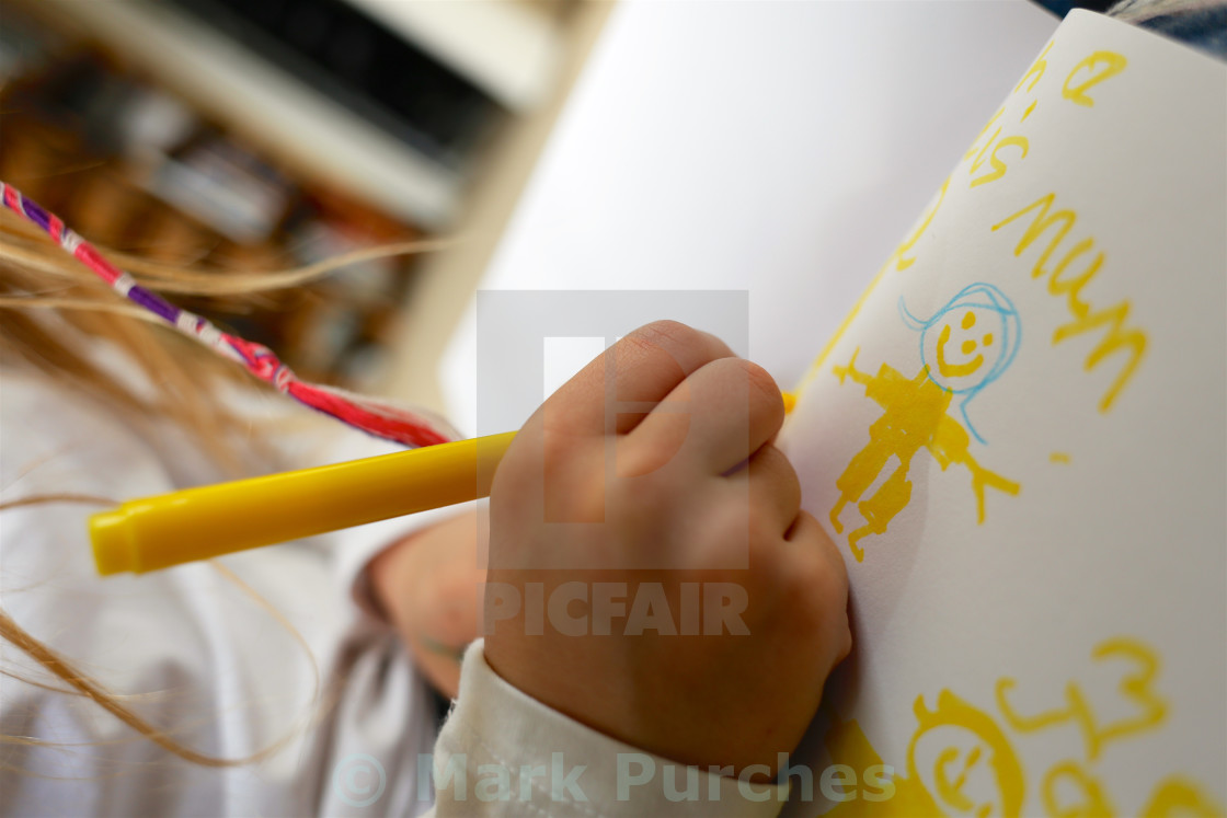 "Girl Drawing Picture of Family for Mothers Day" stock image