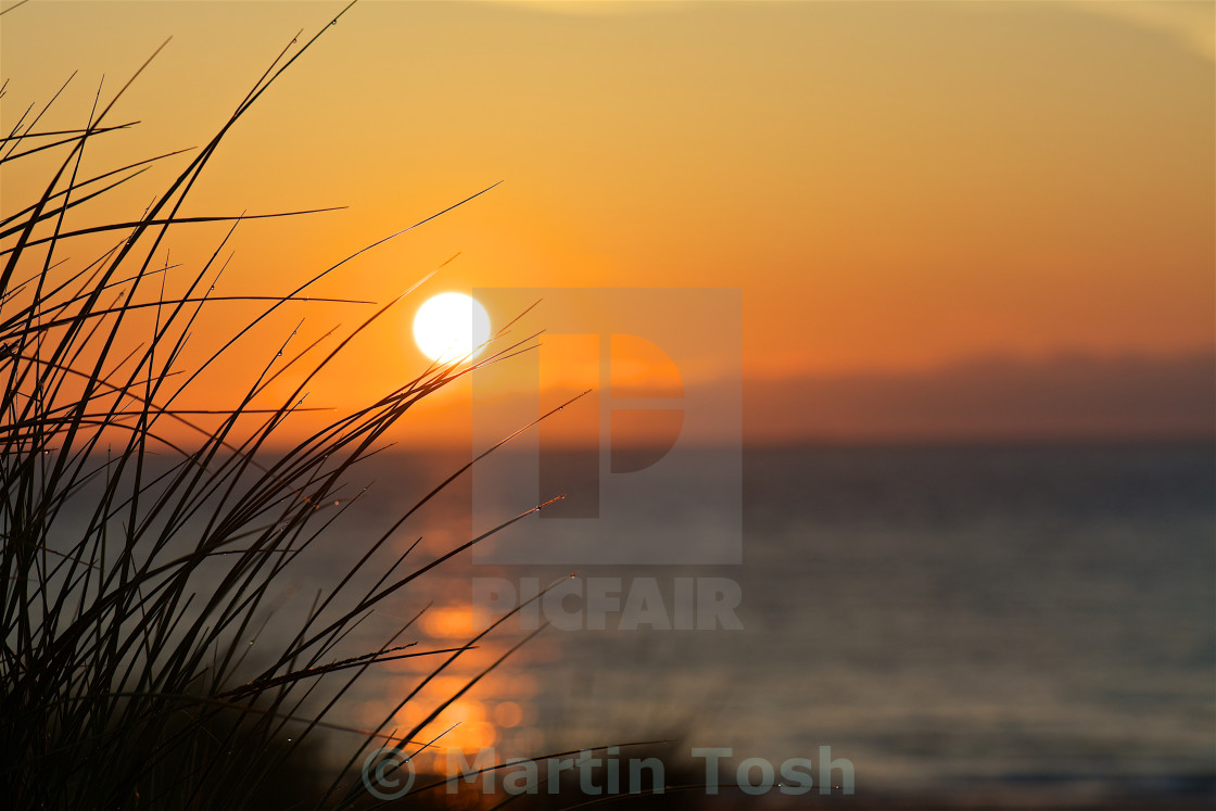 "Dunes rising- sunrise over the dunes and sea" stock image