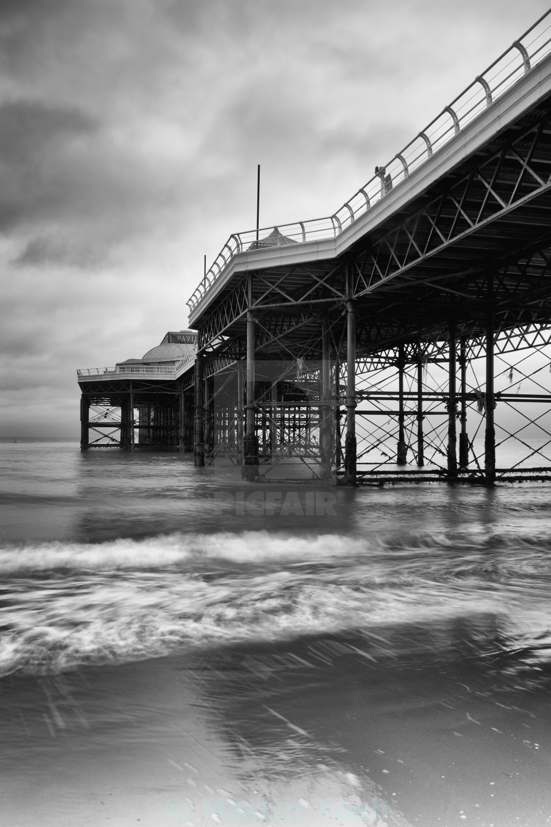 "Piering Out. Cromer pier mono with slow shutter speed" stock image