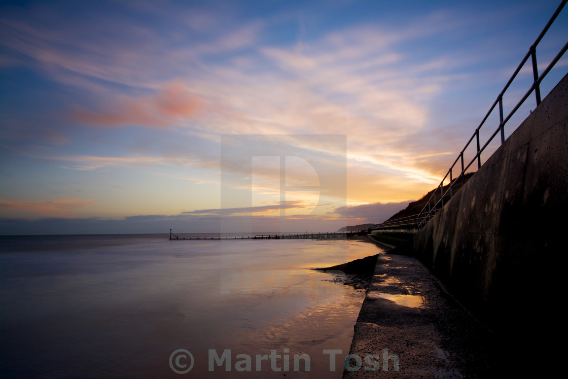 "Soft And Hard- morning sky reflected on the beach by the sea wall" stock image