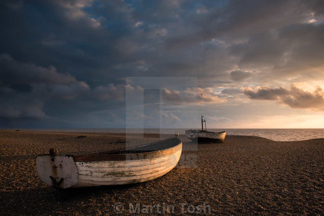 "Ready. Old rowing boats on shingle beach" stock image