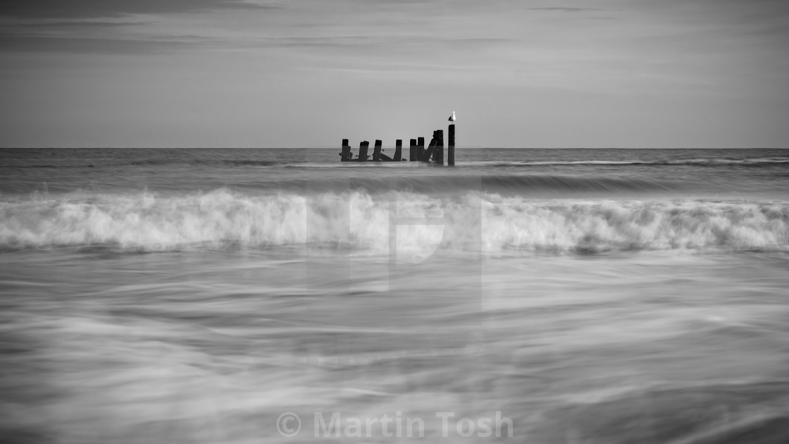 "waves and old sea defences- mono i" stock image