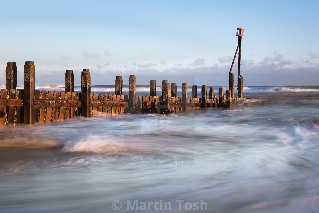 "Morning at Mundesley beach XII. Groyne and swirling sea iii" stock image