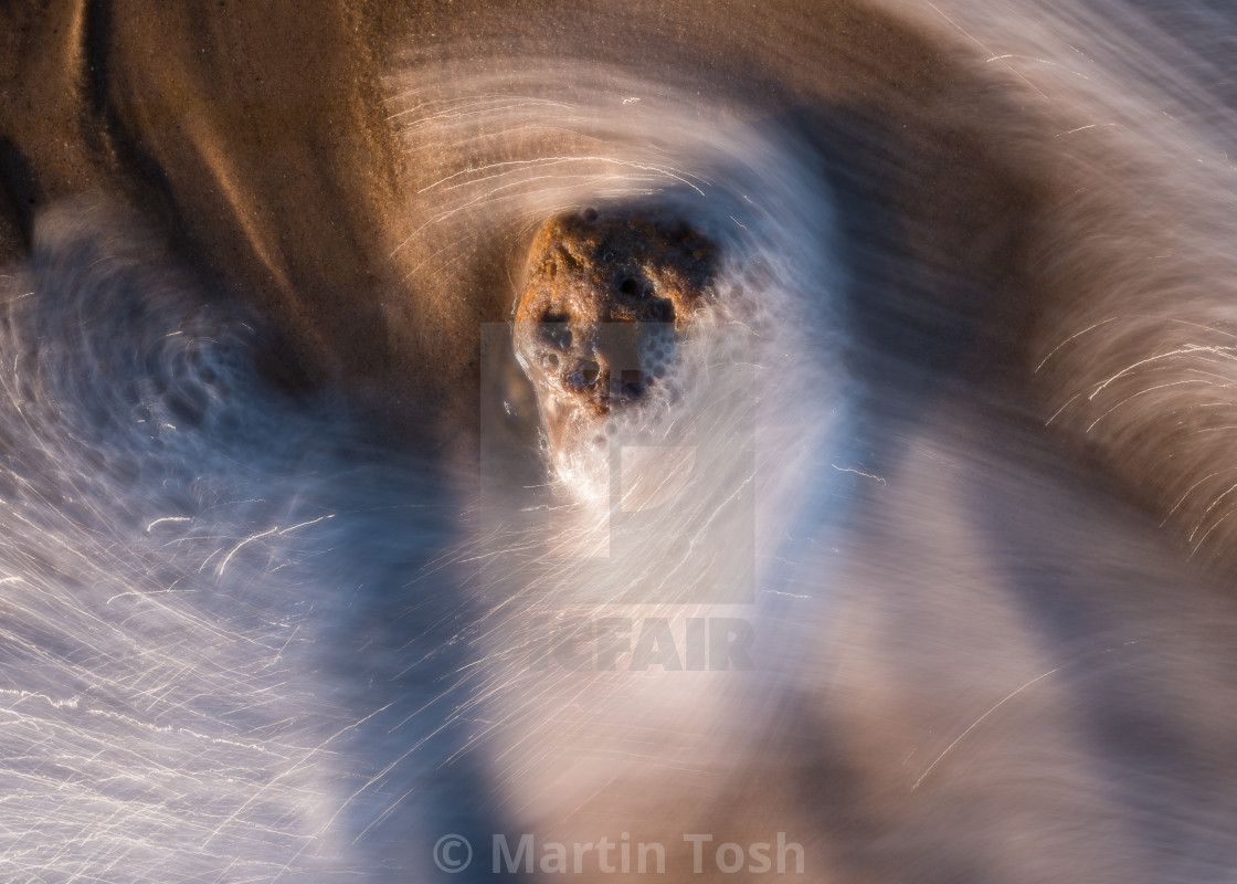 "Beach pebble and swirling sea I" stock image