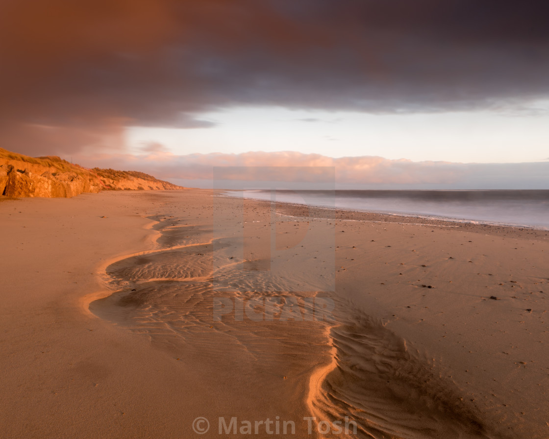 "Colourful Winterton beach morning II.Sand patterns and moody skies ii Smooth sea" stock image