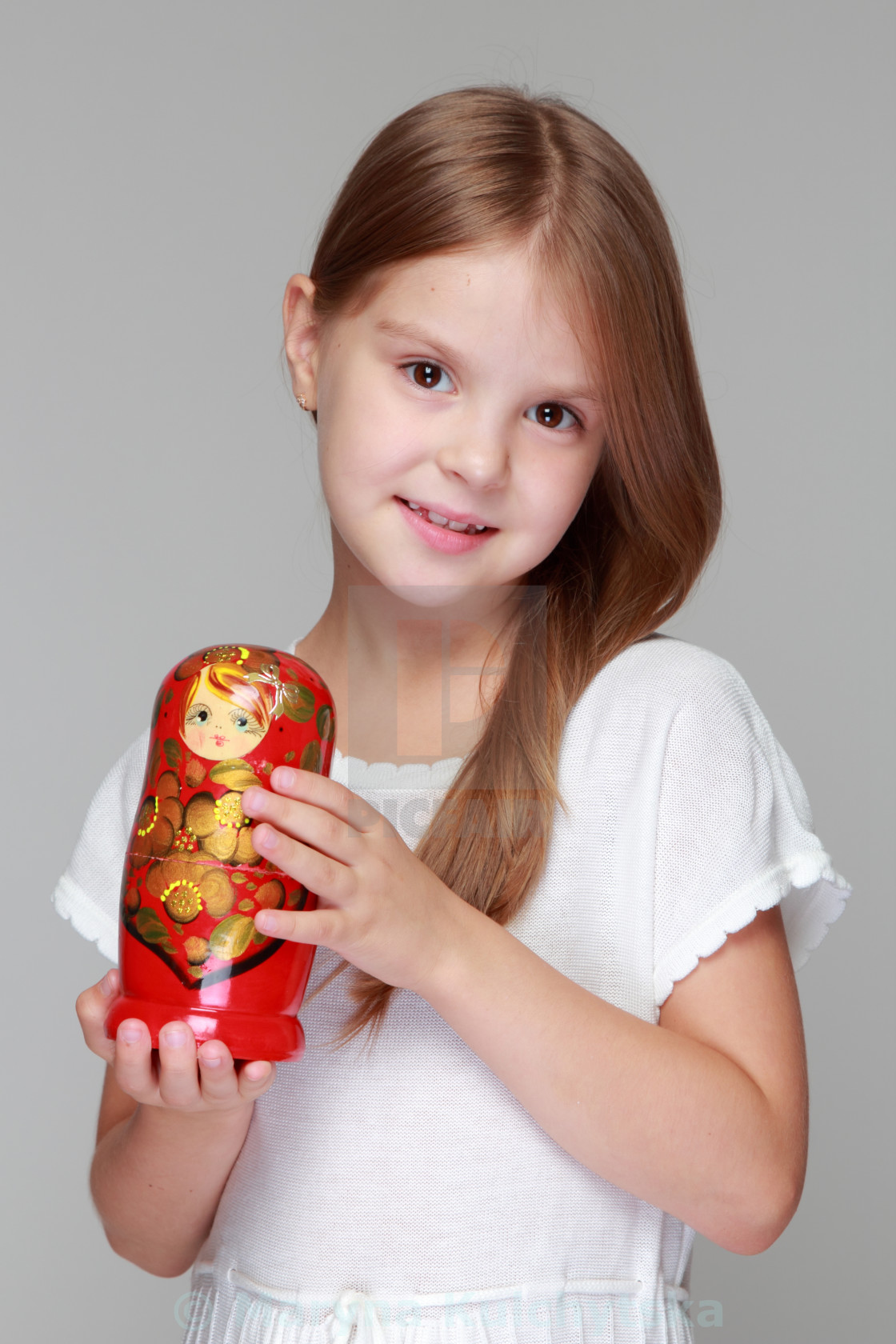 little girl holding doll