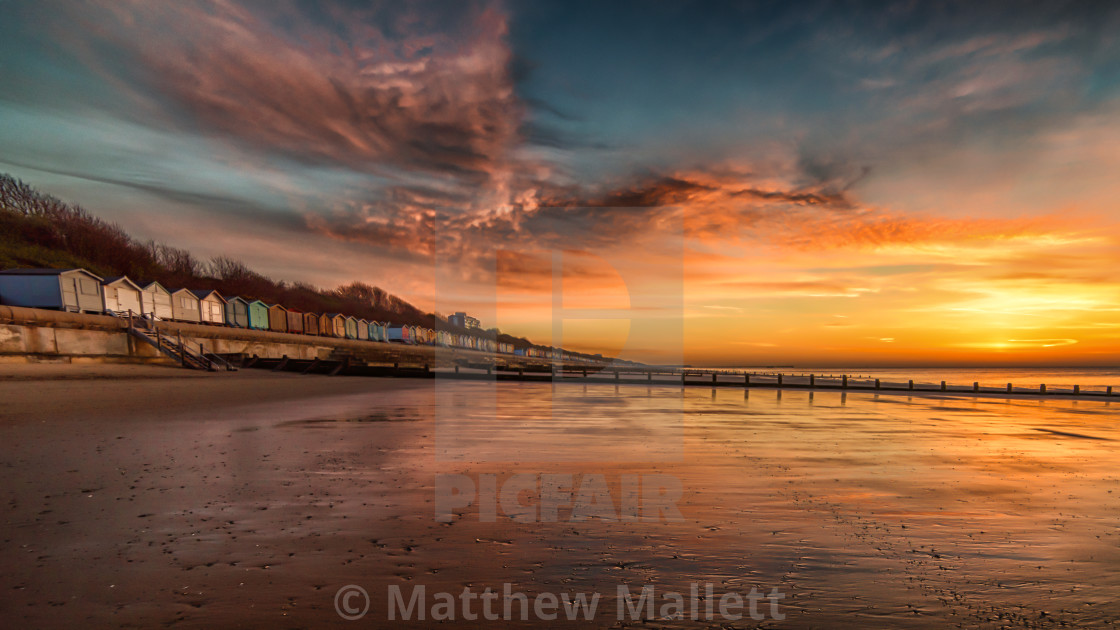 "Red Sky Morning at Frinton Beach" stock image