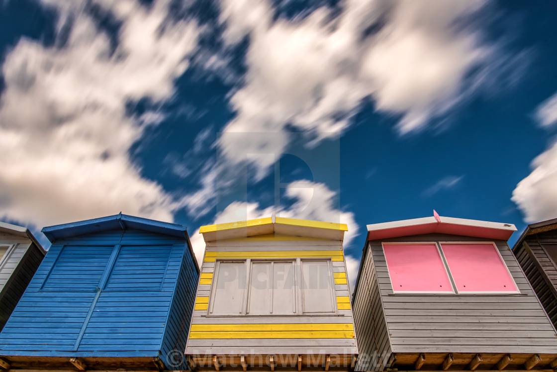 "Passing Clouds Over Beach Huts of Frinton" stock image