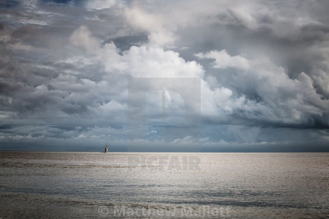 "Small Yacht Big Skies Off Frinton Beach" stock image