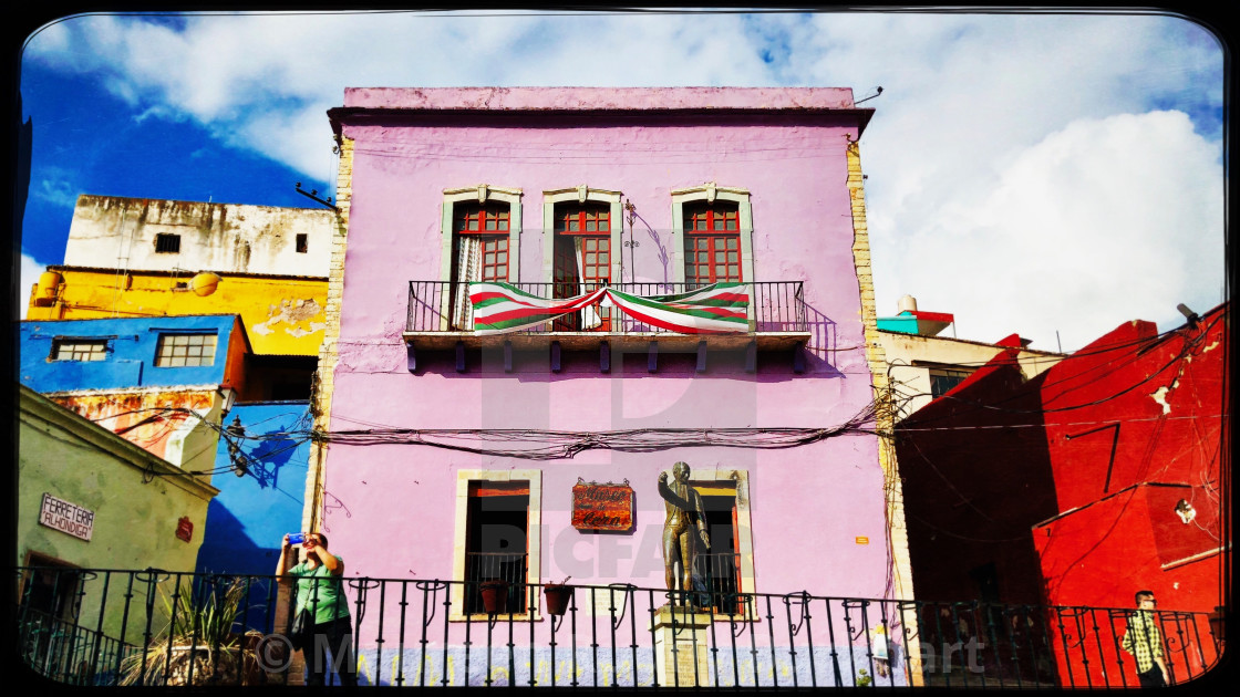 "Mexican Flags adorn Pink Building" by Maureen Ruddy Burkhart - $31.12 "Mexican Flags adorn Pink Building" stock image