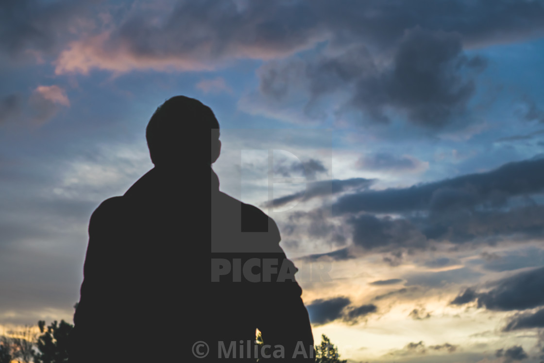 "Silhouette of a man against a dramatic sky 1" by Milica Antic - £12.40 "Silhouette of a man against a dramatic sky 1" stock image