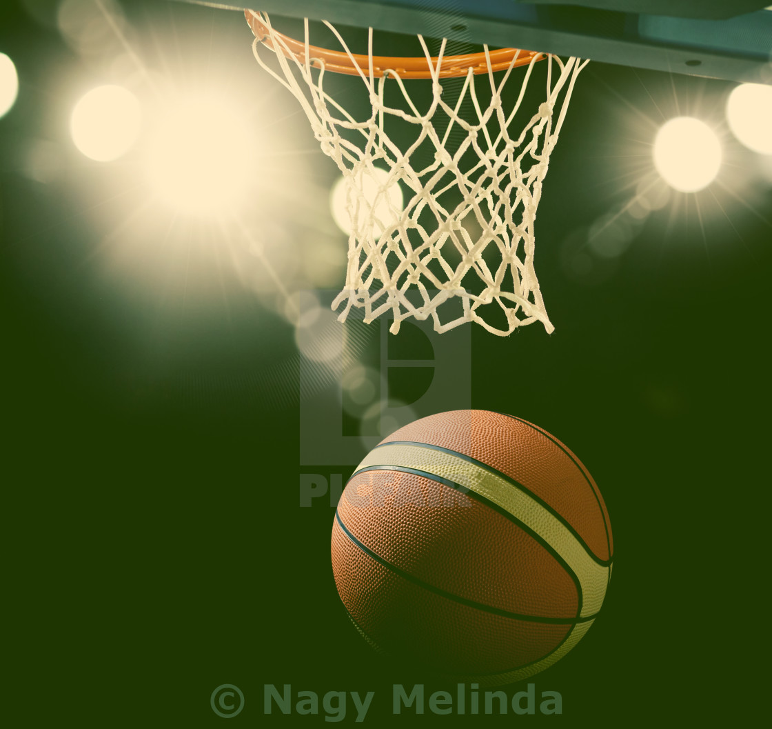 Basketball Going Through The Hoop At A Sports Arena License
